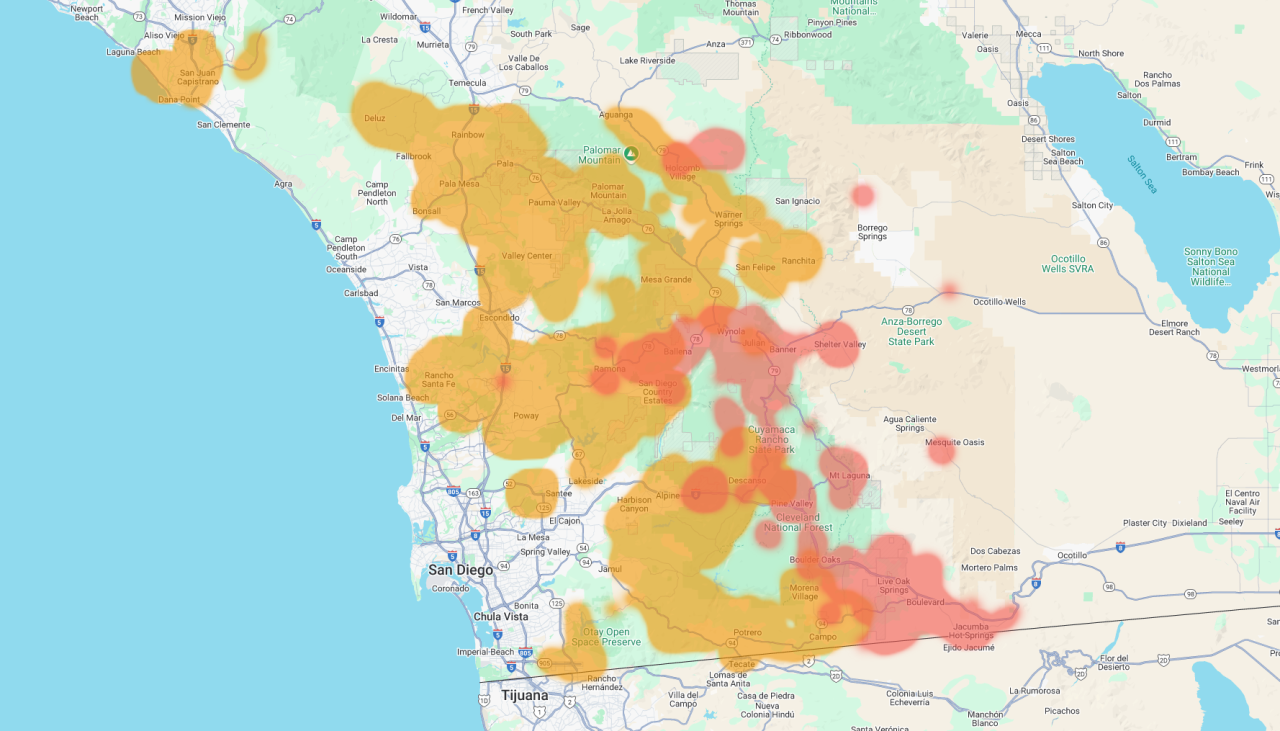 A heat map of San Diego County and surrounding areas showing varying levels of intensity indicated by color gradients from green (low) through yellow and orange to red (high). The map displays geographic features including coastal areas, urban centers like San Diego and Tijuana, and inland regions extending to the desert. Areas of concentrated activity appear in orange and red clusters scattered throughout the county, particularly in central and eastern regions.