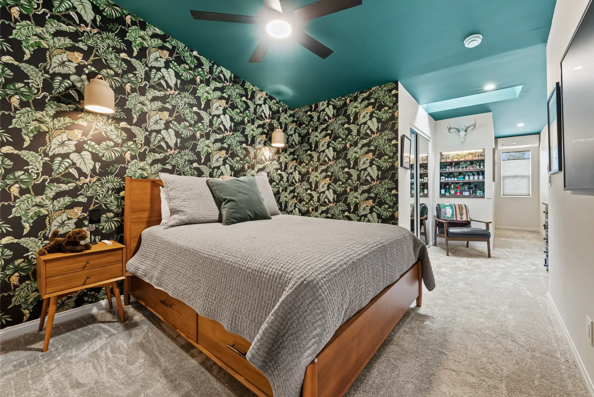Expanded bedroom with botanical accent wall and teal ceiling in a San Diego room addition