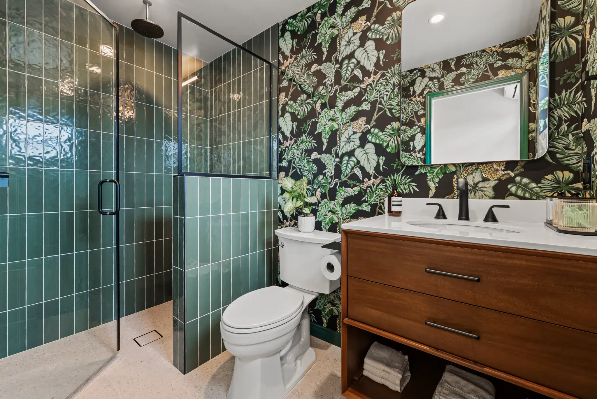 New bathroom with green tile and a wood vanity in a San Diego room addition