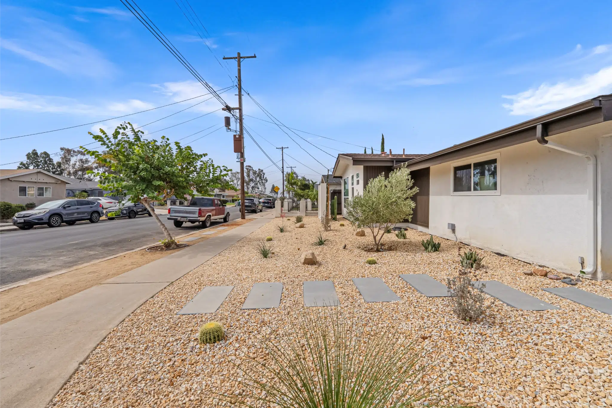 Street view of the updated San Diego home with a xeriscaped front yard