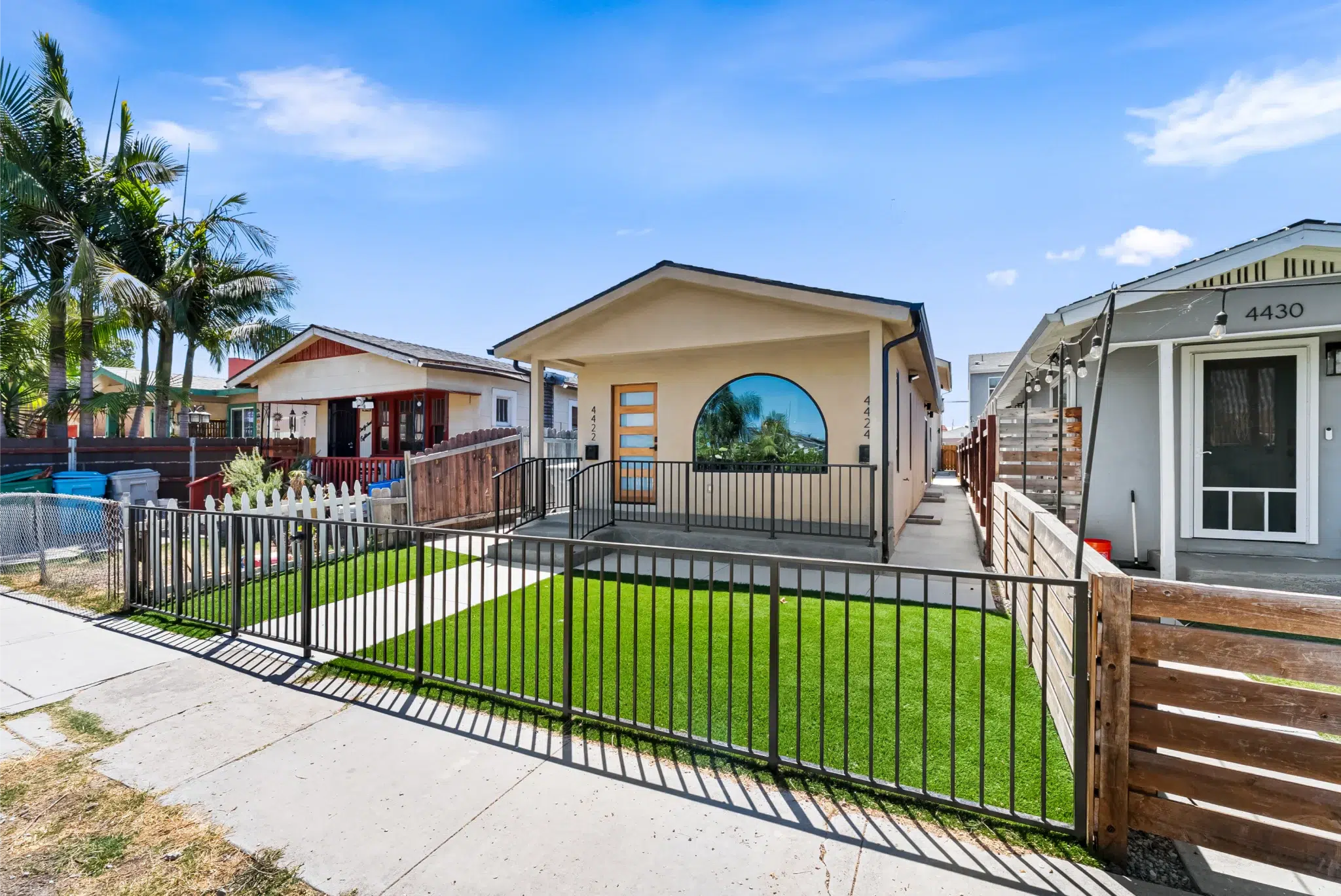 Updated Cherokee Avenue home exterior with landscaping and palms, San Diego