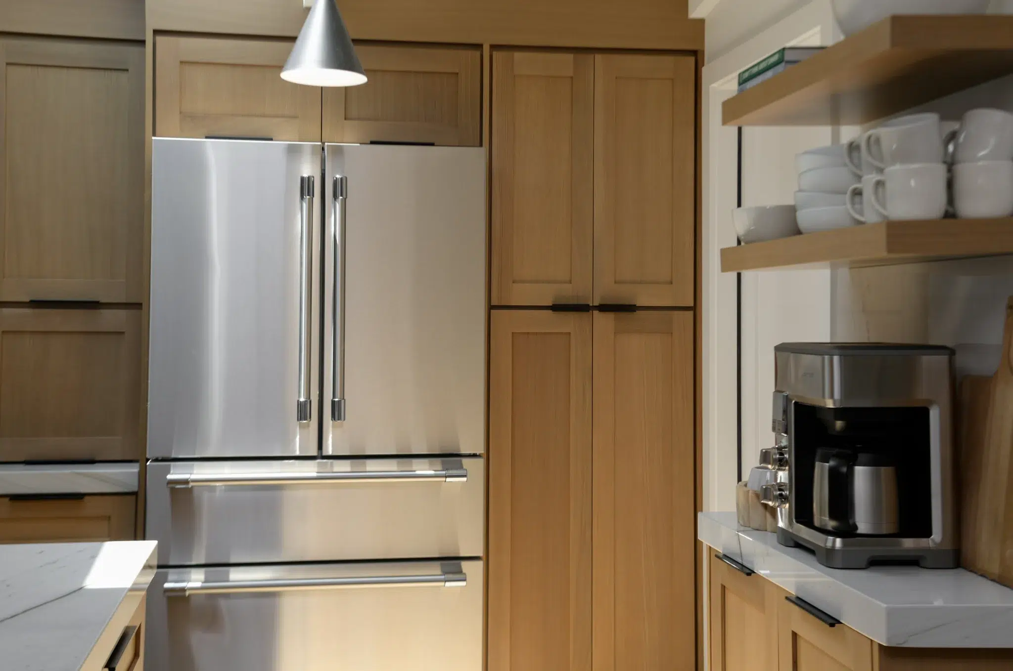 Built-in refrigerator and open shelving in a white oak kitchen remodel, San Diego