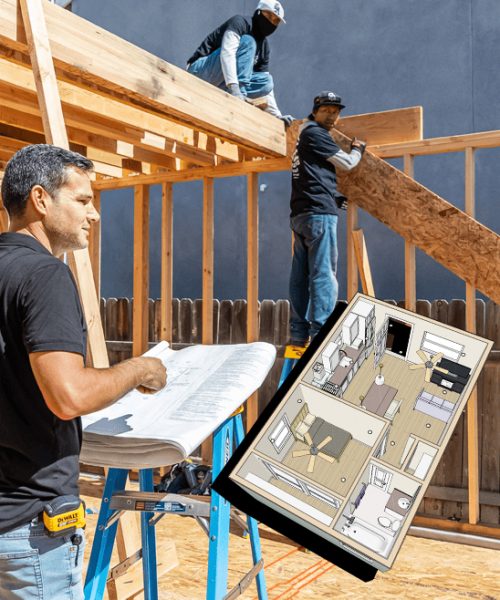 A construction supervisor in a black shirt reviews architectural blueprints on a work table at an active building site, where workers are installing wooden framing and plywood panels on a structure. A detailed floor plan model is visible on the table alongside the blueprints. The scene shows residential construction in progress with exposed wood framing against a dark exterior wall.